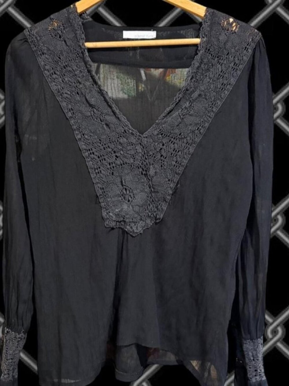 Black lace blouse with long sleeves and a flowy silhouette